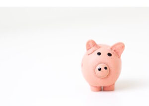 Cute pink piggy bank facing us on white background