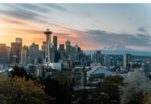 Seattle skyline at sunset with snow-capped mountain in the distance